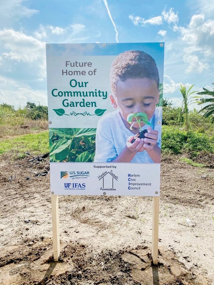 A sign has been posted to alert the community that they will soon enjoy the many benefits of a community garden in Harlem.